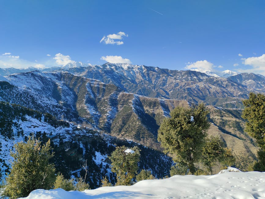 Breathtaking view of snow-capped mountains under a clear blue sky, perfect for travel inspiration.